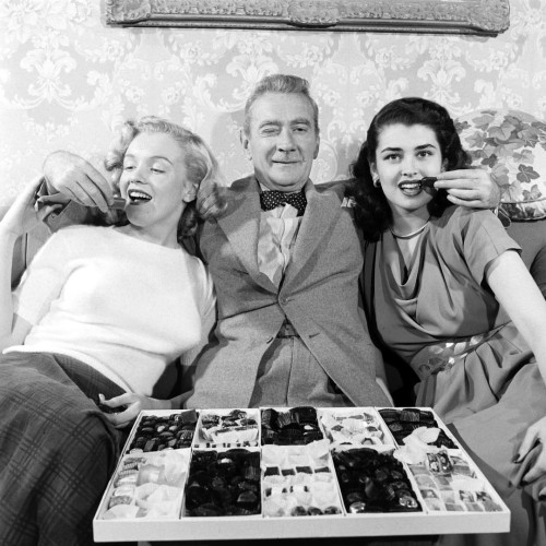 Clifton Webb as a baby-sitter indulging with two women in scene from film "Sitting Pretty."