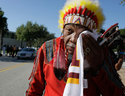 MIAMI - DECEMBER 03: Washington Redskins "unofficial" mascot Zema Williams known as Chief Zee wipes his face as he arrives for the funeral of Redskins football player, Sean Taylor, at the Pharmed Arena at Florida International University December 3, 2007 in Miami, Florida. Taylor died November 27, one day after being shot at his home in Miami. (Photo by Joe Raedle/Getty Images)
